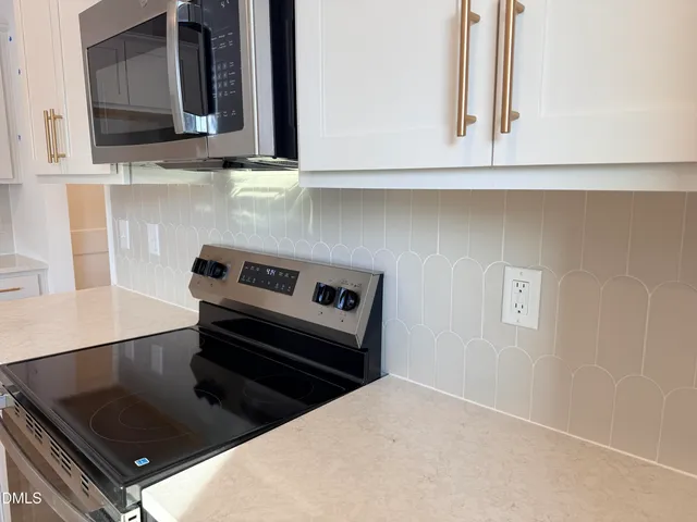 a kitchen with a stove and a microwave