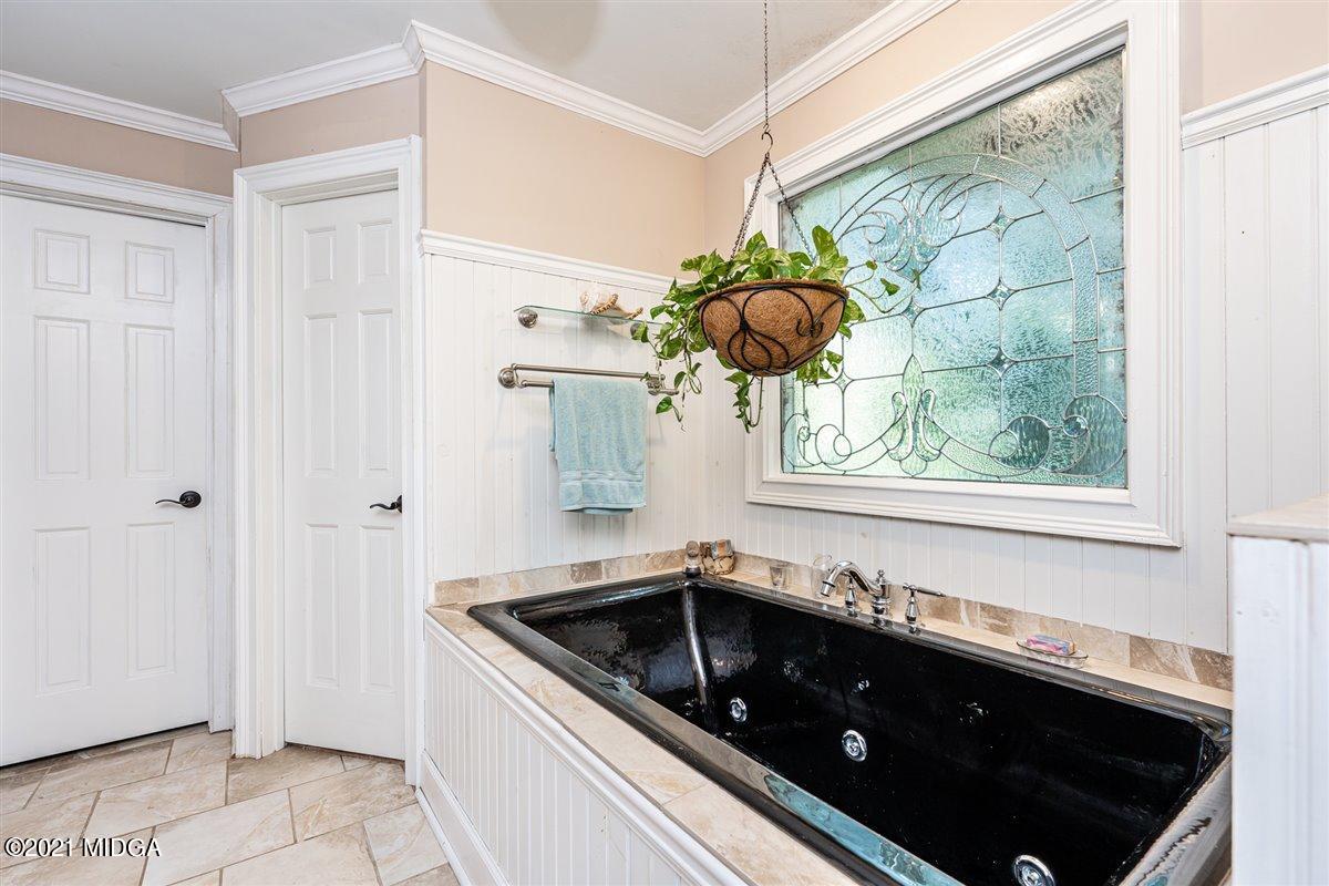 7798 Zebulon Road Macon, GA 31220 - Photo 11 of 35 a kitchen with a sink a stove and cabinets