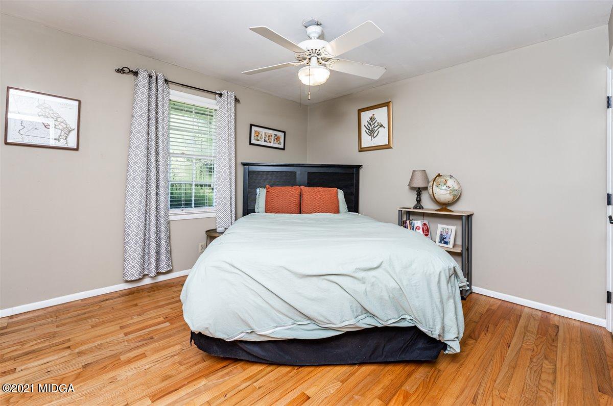 7798 Zebulon Road Macon, GA 31220 - Photo 14 of 35 a bedroom with a bed and wooden floor