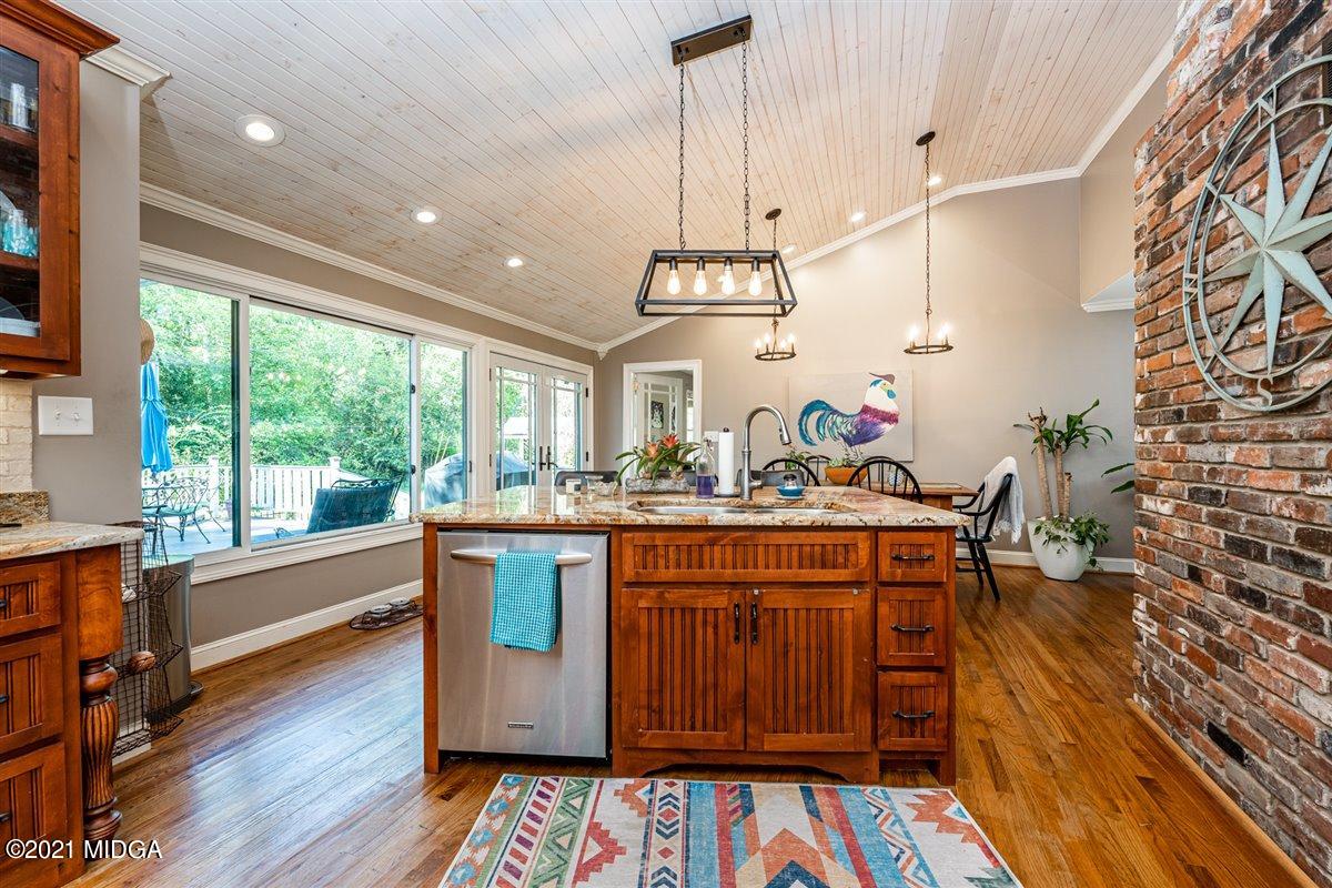 7798 Zebulon Road Macon, GA 31220 - Photo 17 of 35 a view of living room with kitchen island stainless steel appliances wooden floor and large windows
