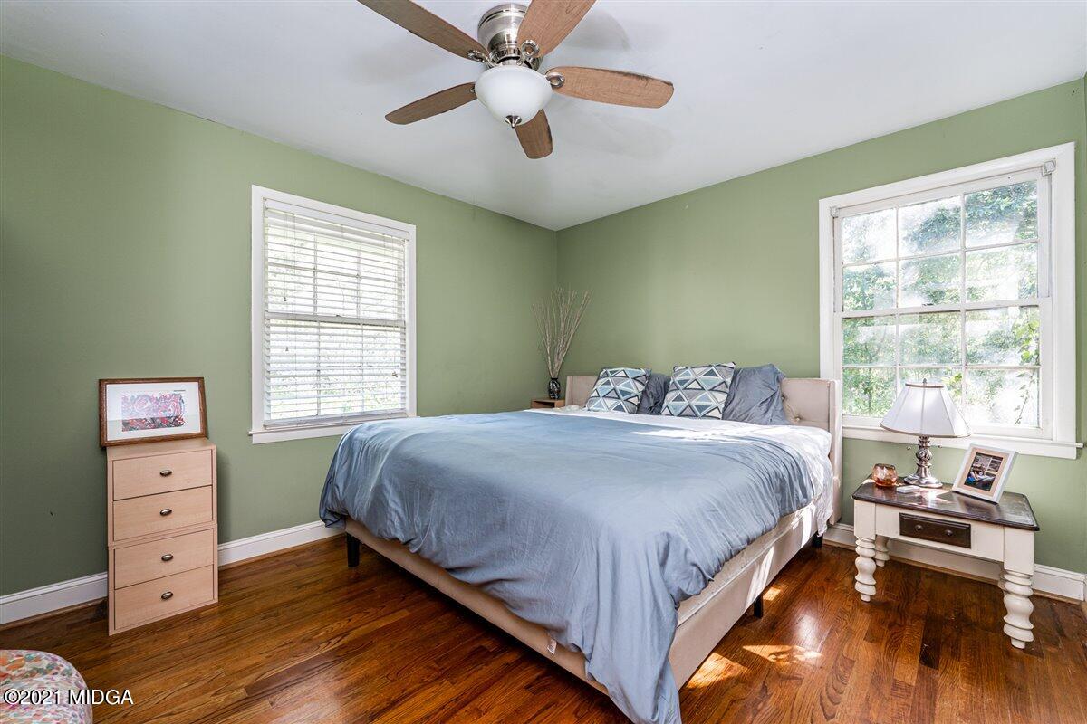 7798 Zebulon Road Macon, GA 31220 - Photo 22 of 35 a bedroom with a bed and a chandelier