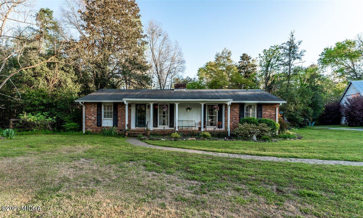 7798 Zebulon Road Macon, GA 31220 - Photo 34 of 35 a front view of a house with a garden