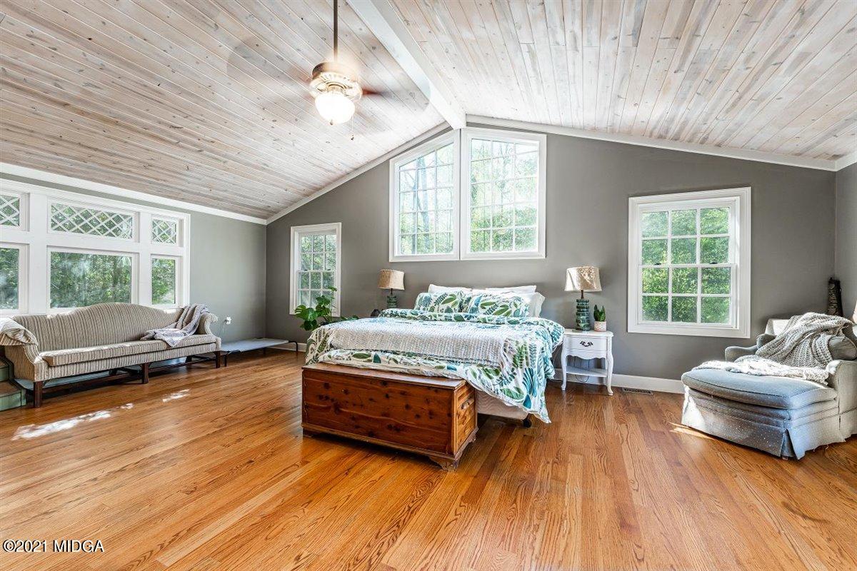 7798 Zebulon Road Macon, GA 31220 - Photo 8 of 35 a bedroom with a bed and a large window with wooden floor