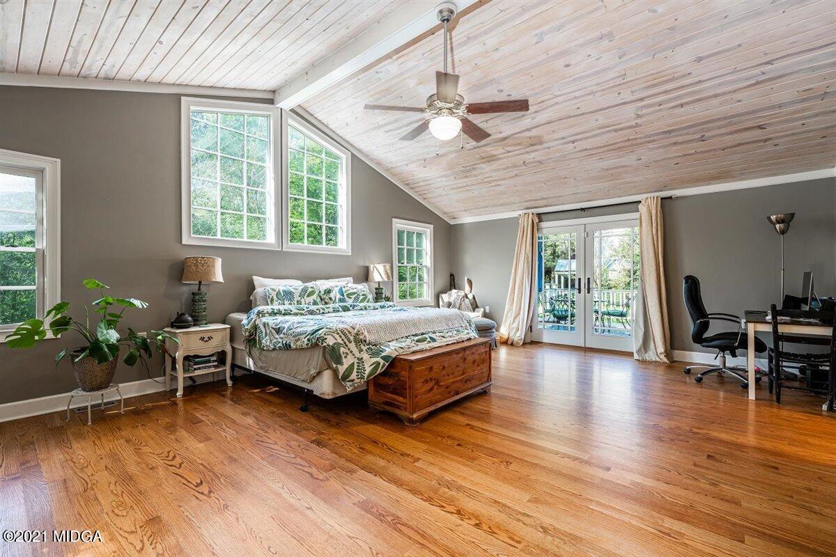 7798 Zebulon Road Macon, GA 31220 - Photo 9 of 35 a bedroom with wooden floors bed and windows