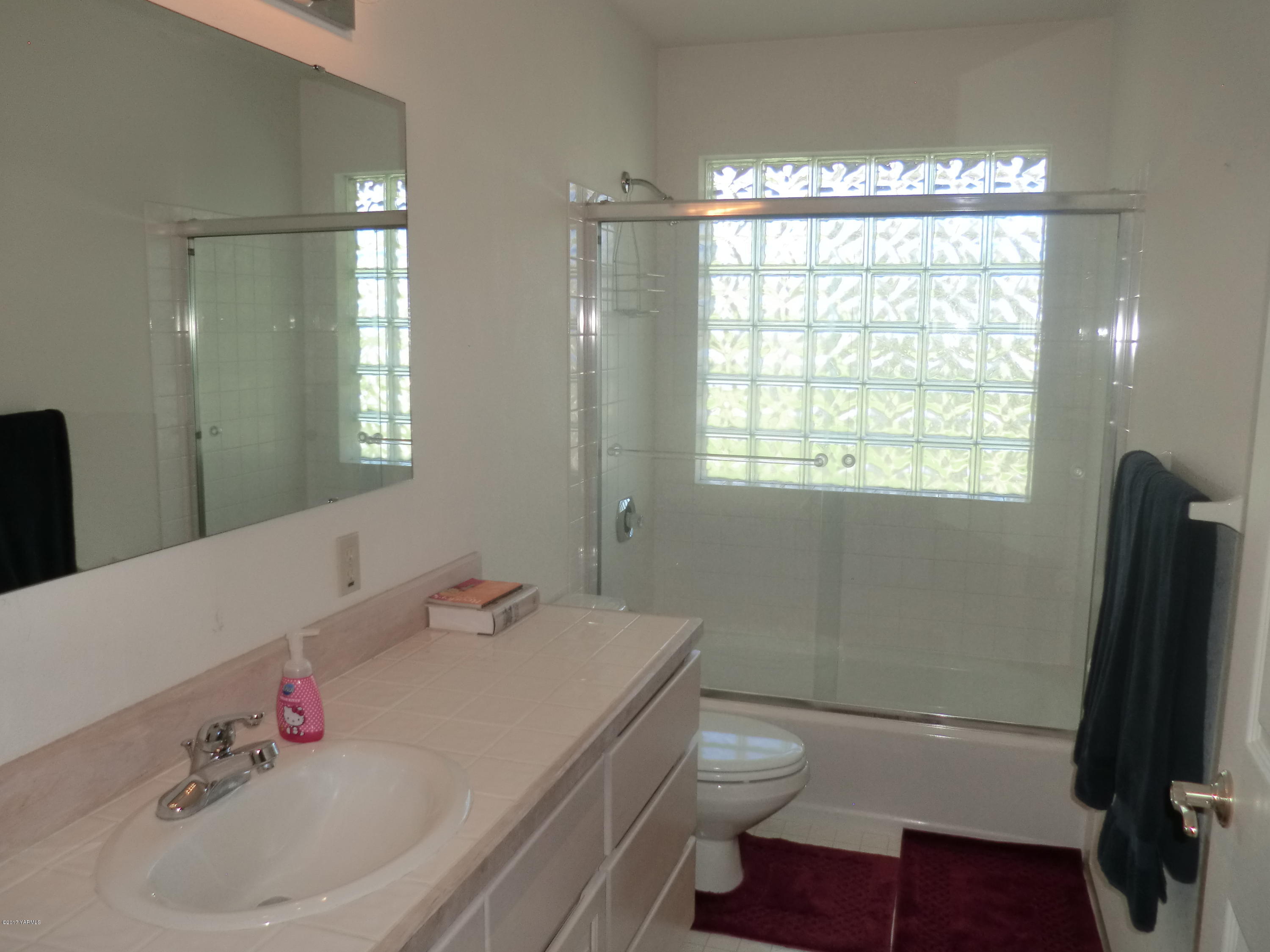 14721 Fisk Road Yakima, WA 98908 - Photo 12 of 20 a bathroom with a sink a toilet and a mirror
