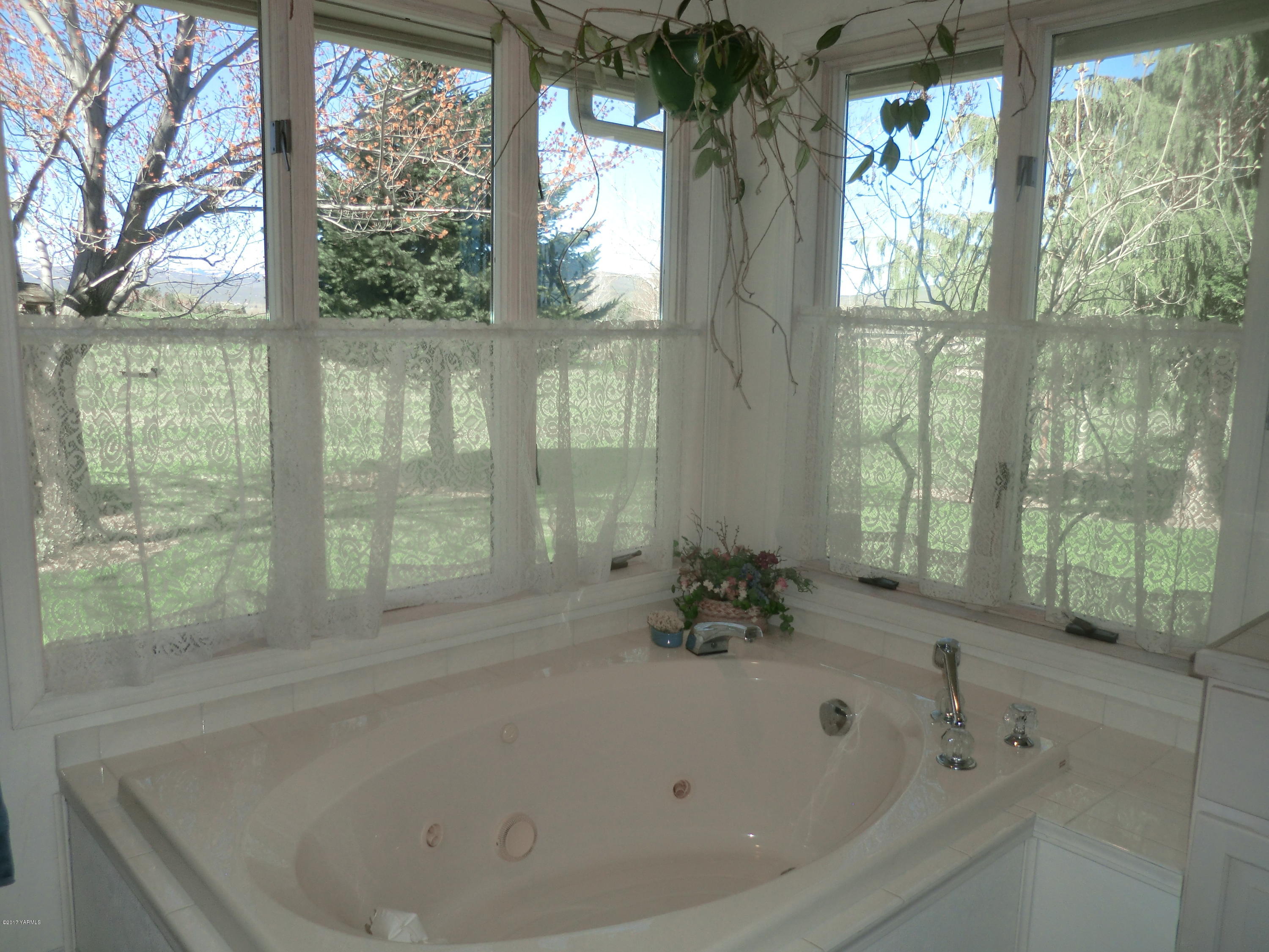 14721 Fisk Road Yakima, WA 98908 - Photo 16 of 20 a white bath tub sitting in a bathroom next to a window