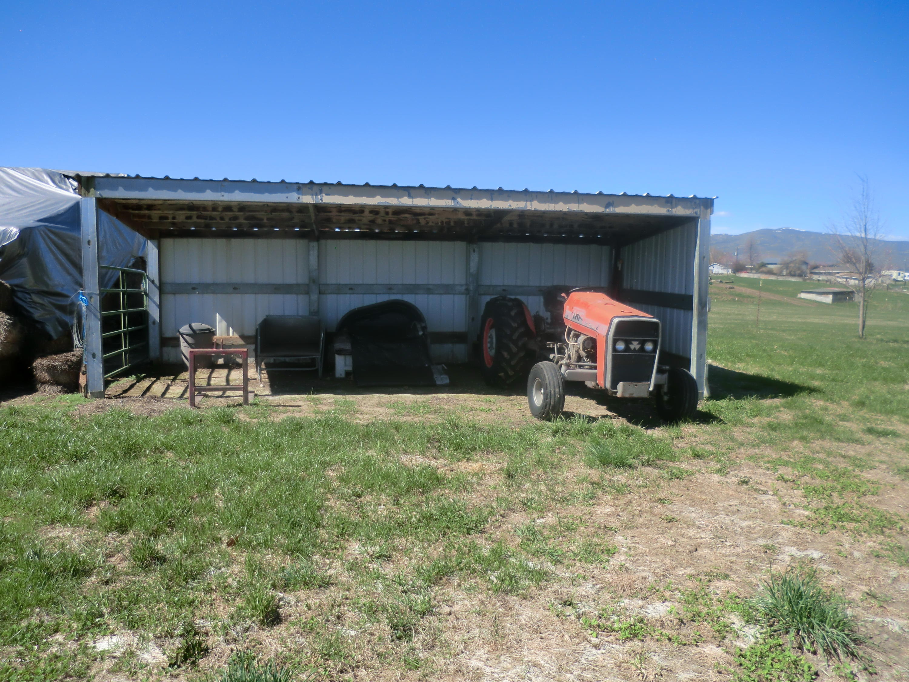 14721 Fisk Road Yakima, WA 98908 - Photo 20 of 20 a view of a wooden house with a yard and a car park