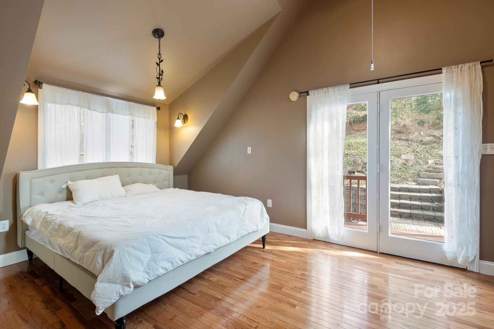 1506 Lynn Road Columbus, NC 28722 - Photo 16 of 30 a large bed sitting in a spacious bedroom next to a window