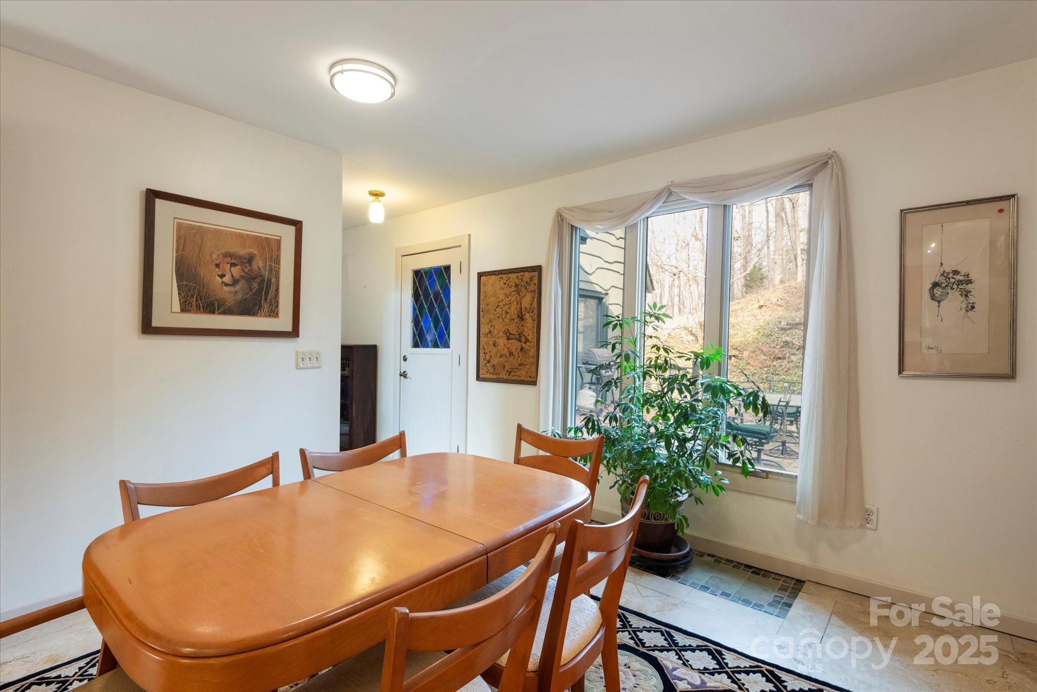 1506 Lynn Road Columbus, NC 28722 - Photo 19 of 30 a view of a dining room with furniture and a potted plant