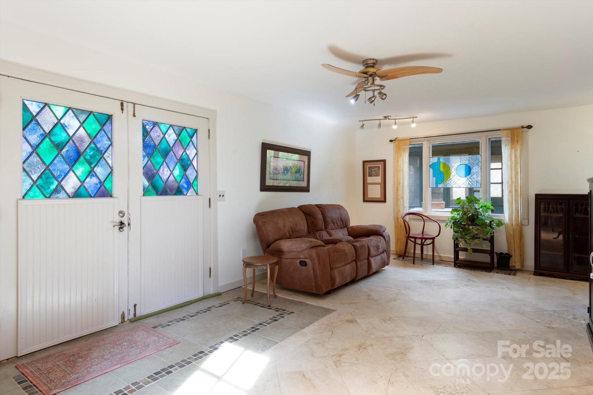 1506 Lynn Road Columbus, NC 28722 - Photo 21 of 30 a living room with furniture and a ceiling fan