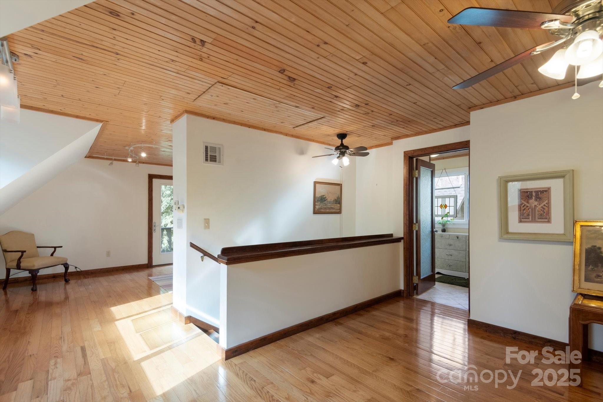 1506 Lynn Road Columbus, NC 28722 - Photo 10 of 30 a view of a hallway with wooden floor and furniture