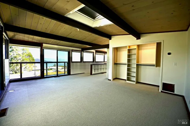 a view of an empty room with a balcony