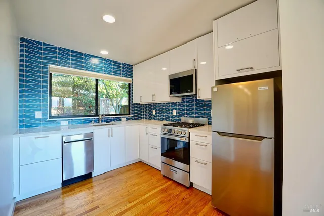 a kitchen with a refrigerator stove and microwave