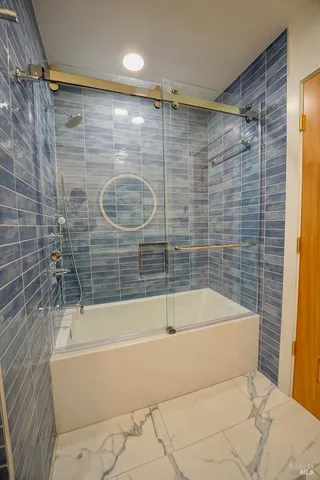 a bathroom with a bathtub and shower