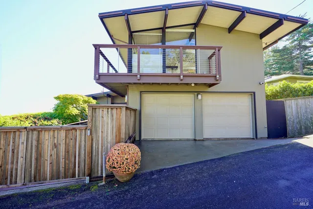 a view of a house with wooden fence