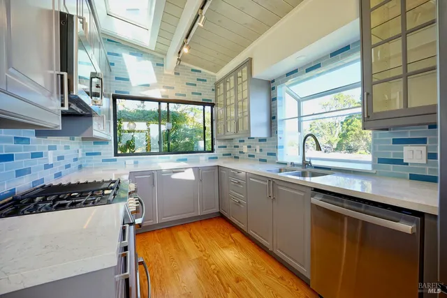 a kitchen with a sink stove top oven and cabinets