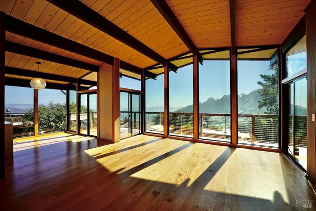 a bedroom with a bed and a large window with outer view