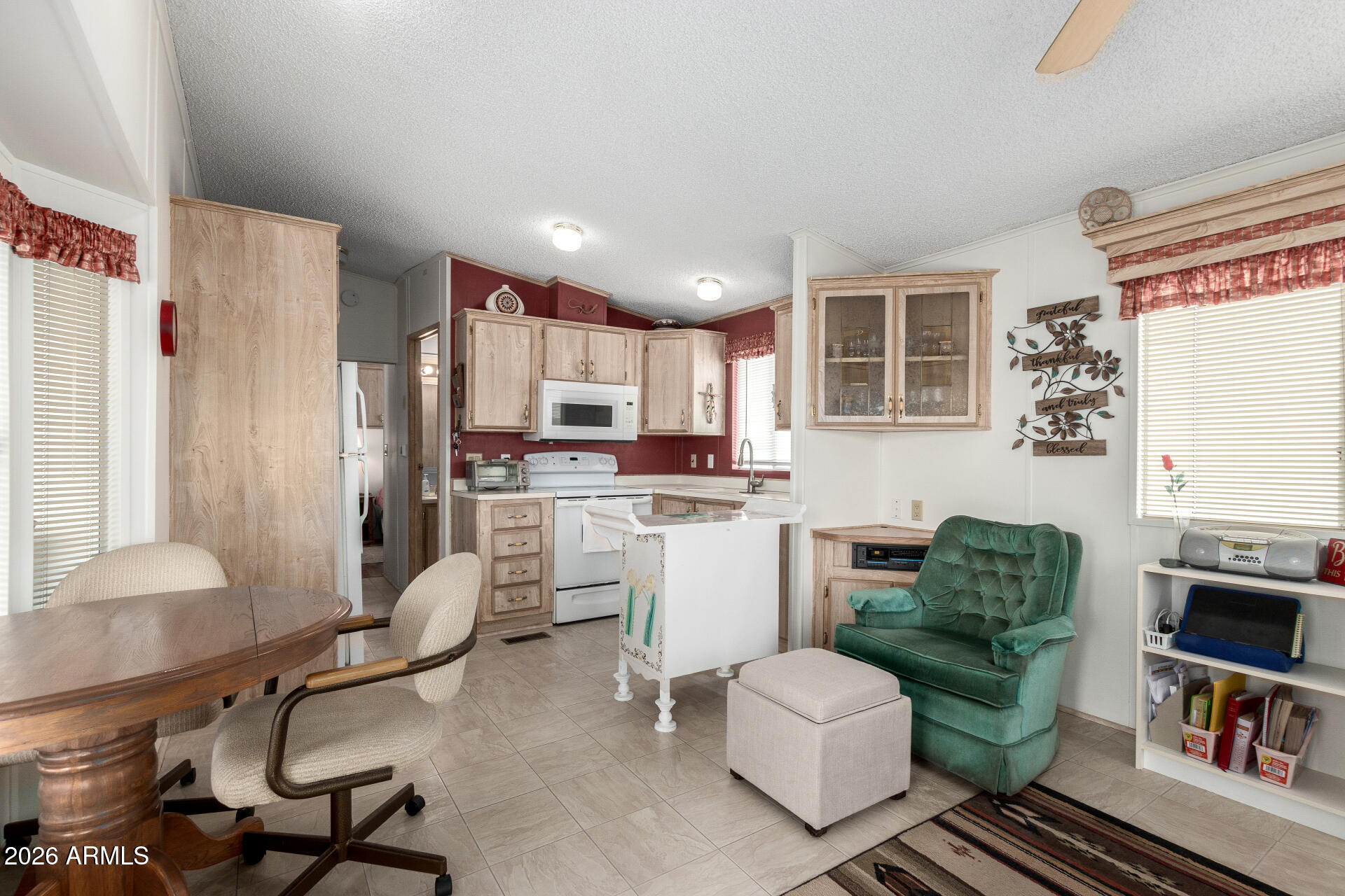 7750 East Broadway Road, Unit 533 Mesa, AZ 85208 - Photo 11 of 21 a living room with furniture and a dining table with kitchen view