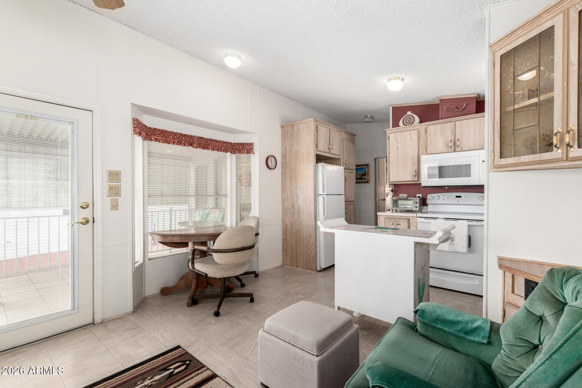 7750 East Broadway Road, Unit 533 Mesa, AZ 85208 - Photo 13 of 21 a living room with furniture a large window and chairs