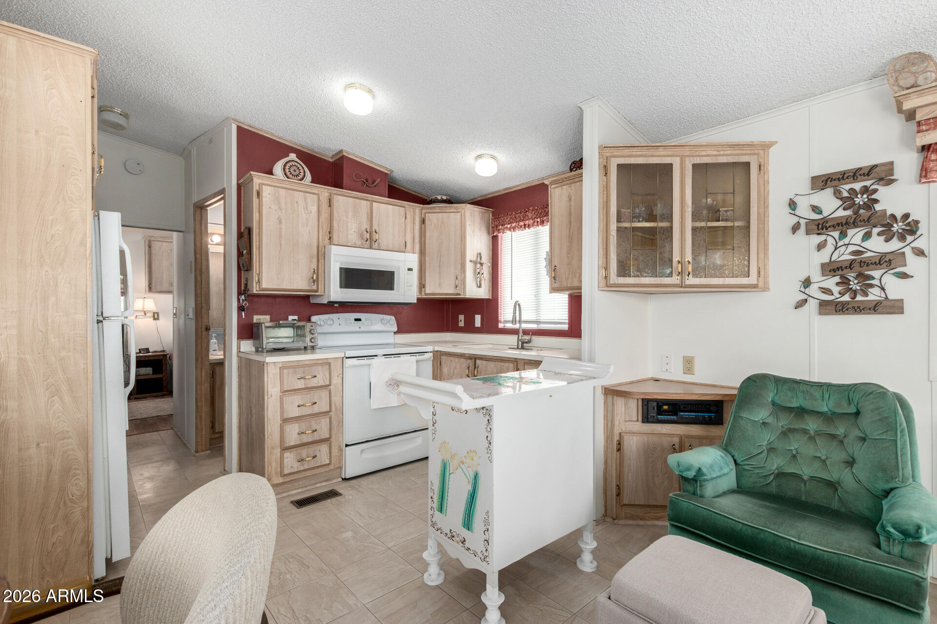 7750 East Broadway Road, Unit 533 Mesa, AZ 85208 - Photo 14 of 21 a kitchen with white cabinets and stainless steel appliances