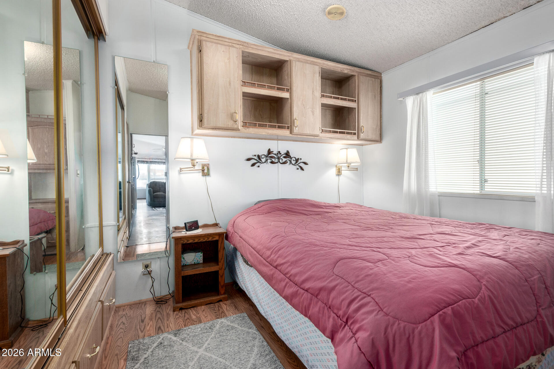 7750 East Broadway Road, Unit 533 Mesa, AZ 85208 - Photo 17 of 21 a bedroom with a bed and a flat tv screen