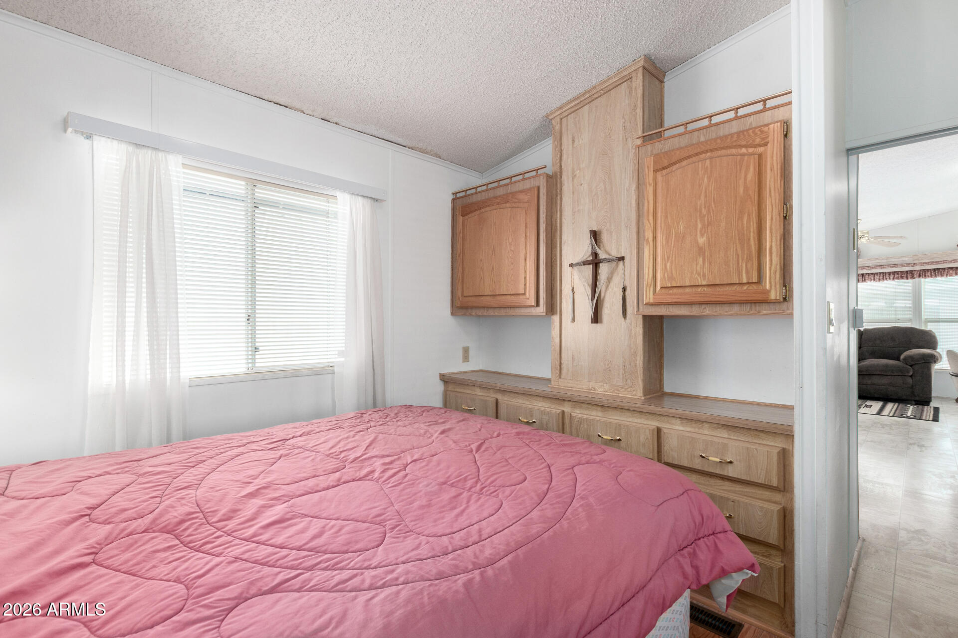 7750 East Broadway Road, Unit 533 Mesa, AZ 85208 - Photo 18 of 21 a bedroom with a bed and a cabinets