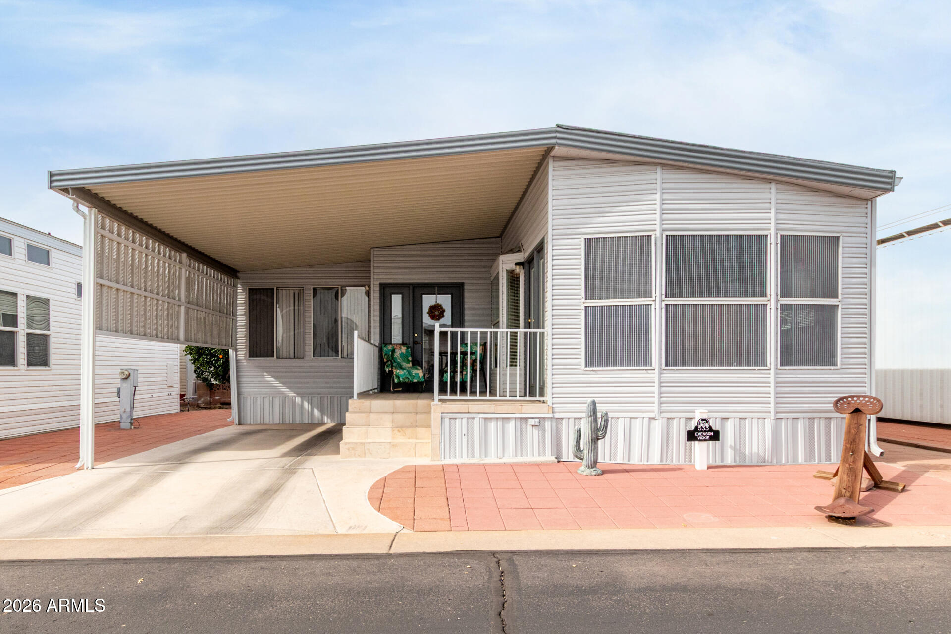 7750 East Broadway Road, Unit 533 Mesa, AZ 85208 - Photo 2 of 21 a view of a house with a swimming pool and sitting area