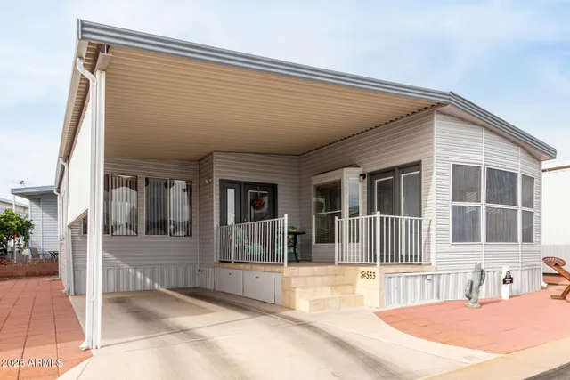 a view of a house with a wooden fence