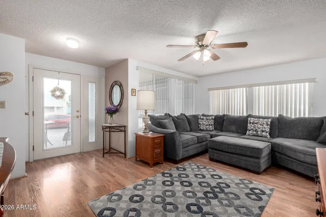a living room with furniture and a mirror