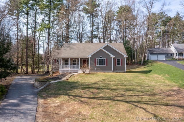 a front view of a house with a yard and trees
