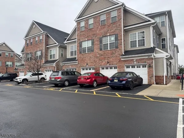 a couple of cars parked in front of a building