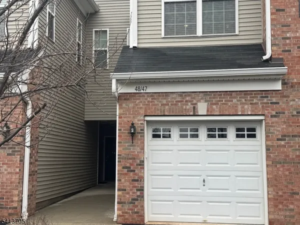 a view of a building with a door and a large window
