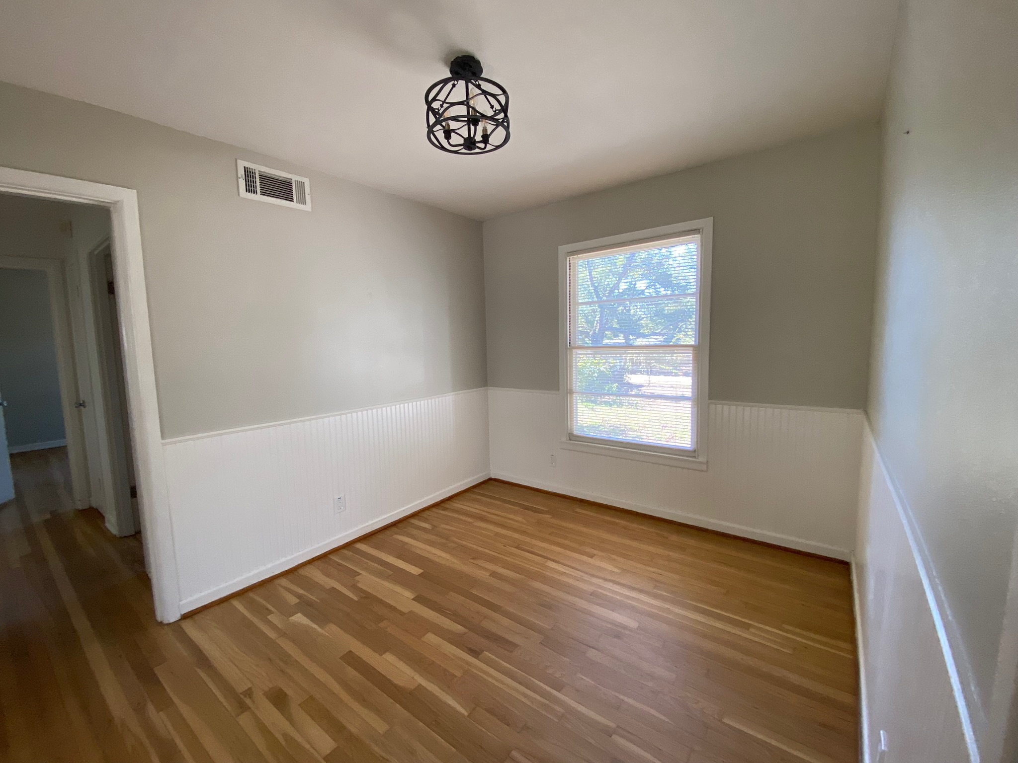 1818 South 39th Street Temple, TX 76504 - Photo 7 of 14 Dining room with a wainscoted wall and light wood-style flooring