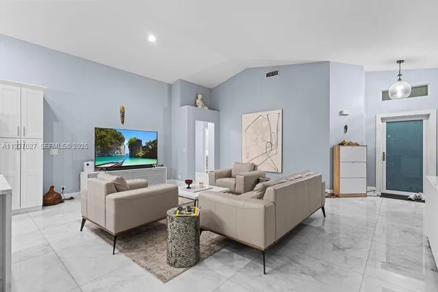 a living room with furniture and a flat screen tv