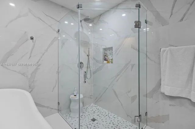 a bathroom with a shower and a shower