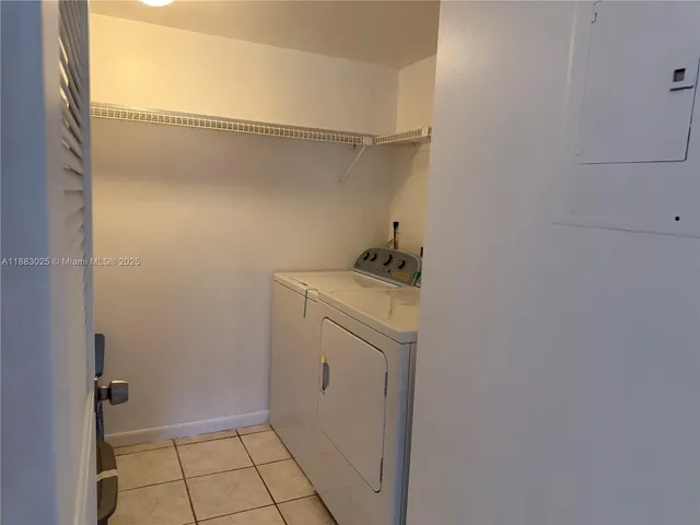 a view of a room with wooden floor and a ceiling fan