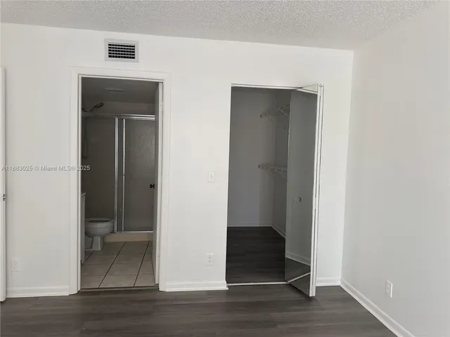 a bathroom with a glass shower door