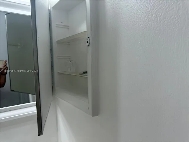 a bathroom with a toilet sink vanity and shower