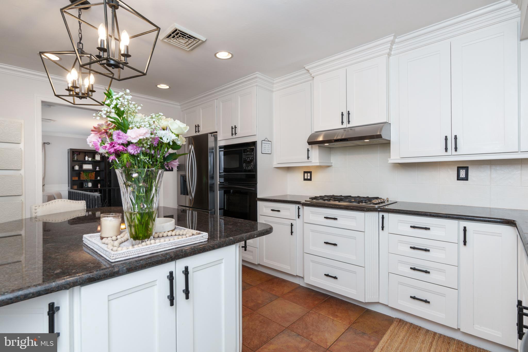 1411 Greenhill Road West Chester, PA 19380 - Photo 16 of 40 a kitchen with stainless steel appliances granite countertop a sink a stove and cabinets