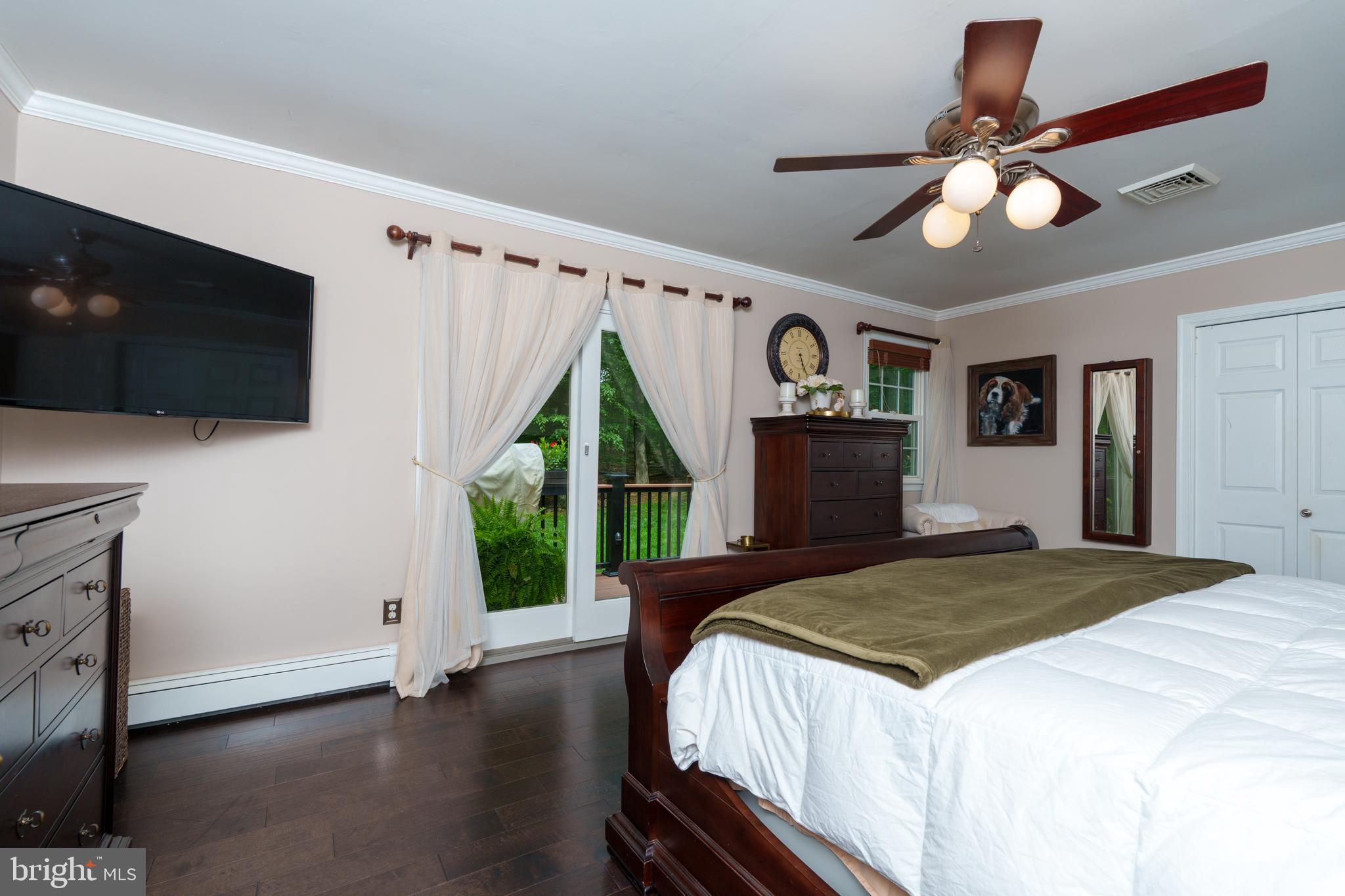 1411 Greenhill Road West Chester, PA 19380 - Photo 19 of 40 a bedroom with a bed and a flat tv screen on dresser