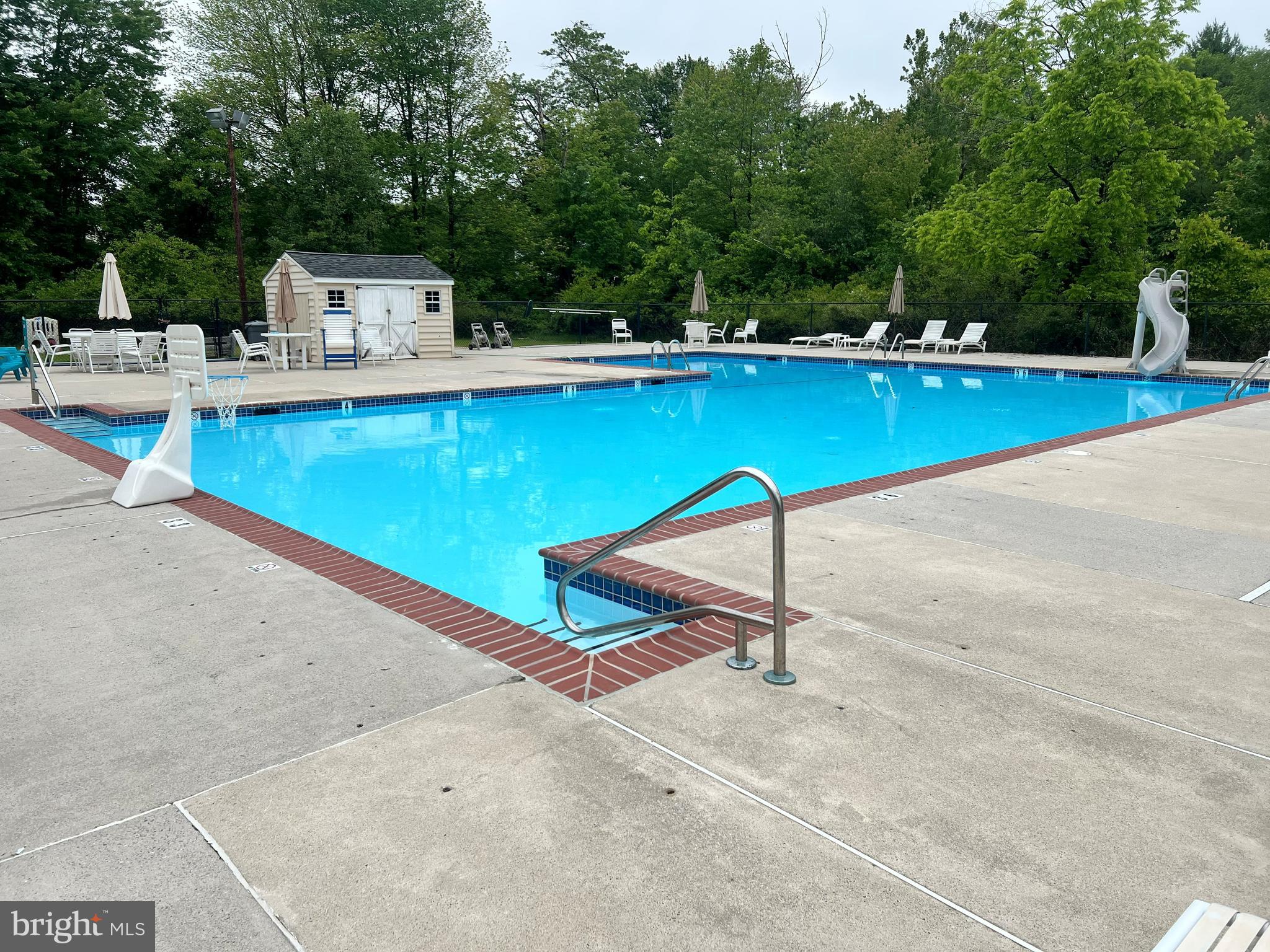 1411 Greenhill Road West Chester, PA 19380 - Photo 39 of 40 a view of a swimming pool with a chair and tables