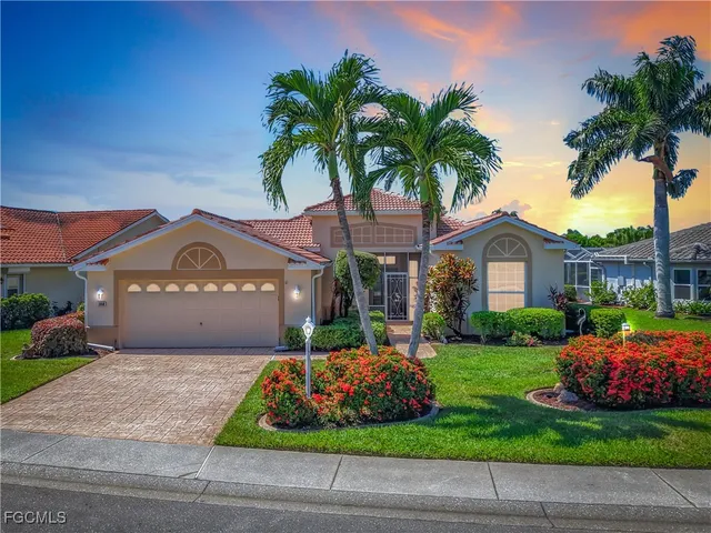 a front view of a house with a garden and plants