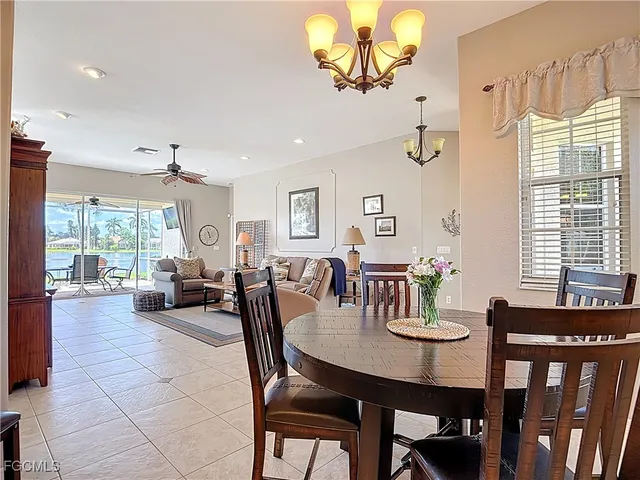 a view of a dining room and livingroom with furniture wooden floor and a chandelier