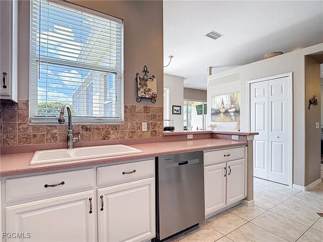 a kitchen with a sink and cabinets