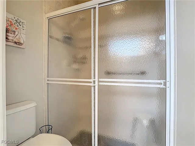 a bathroom with a glass shower door