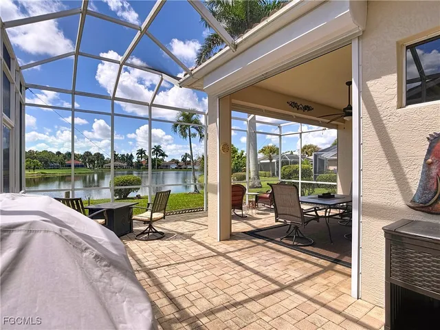 a view of an chairs and table in patio with a yard