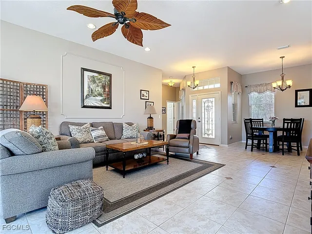 a living room with furniture and a chandelier