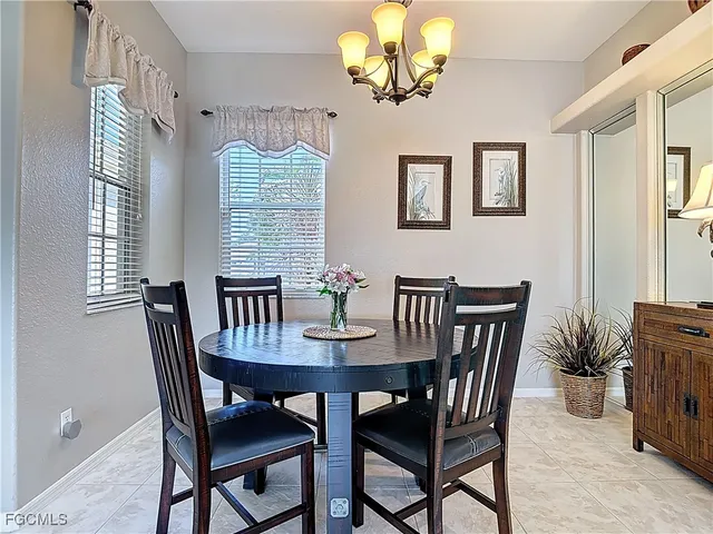 a view of a dining room with furniture wooden floor and chandelier