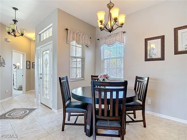 a view of a dining room with furniture and chandelier