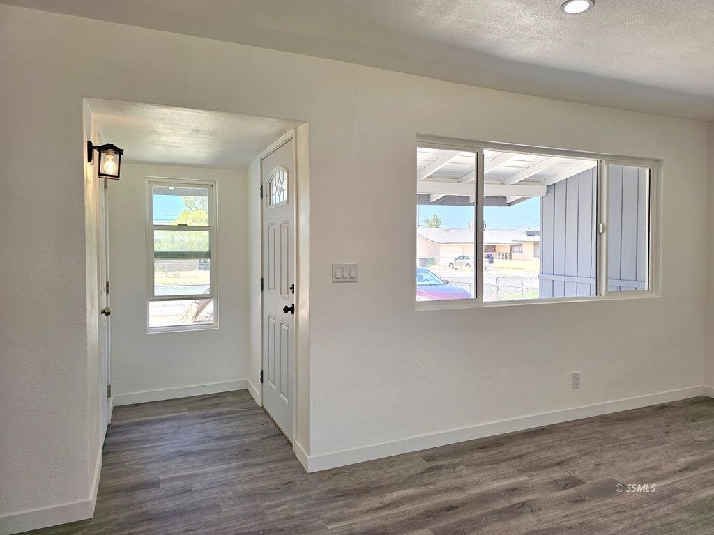 247 West Perdew Avenue Ridgecrest, CA 93555 - Photo 22 of 24 an empty room with wooden floor and windows